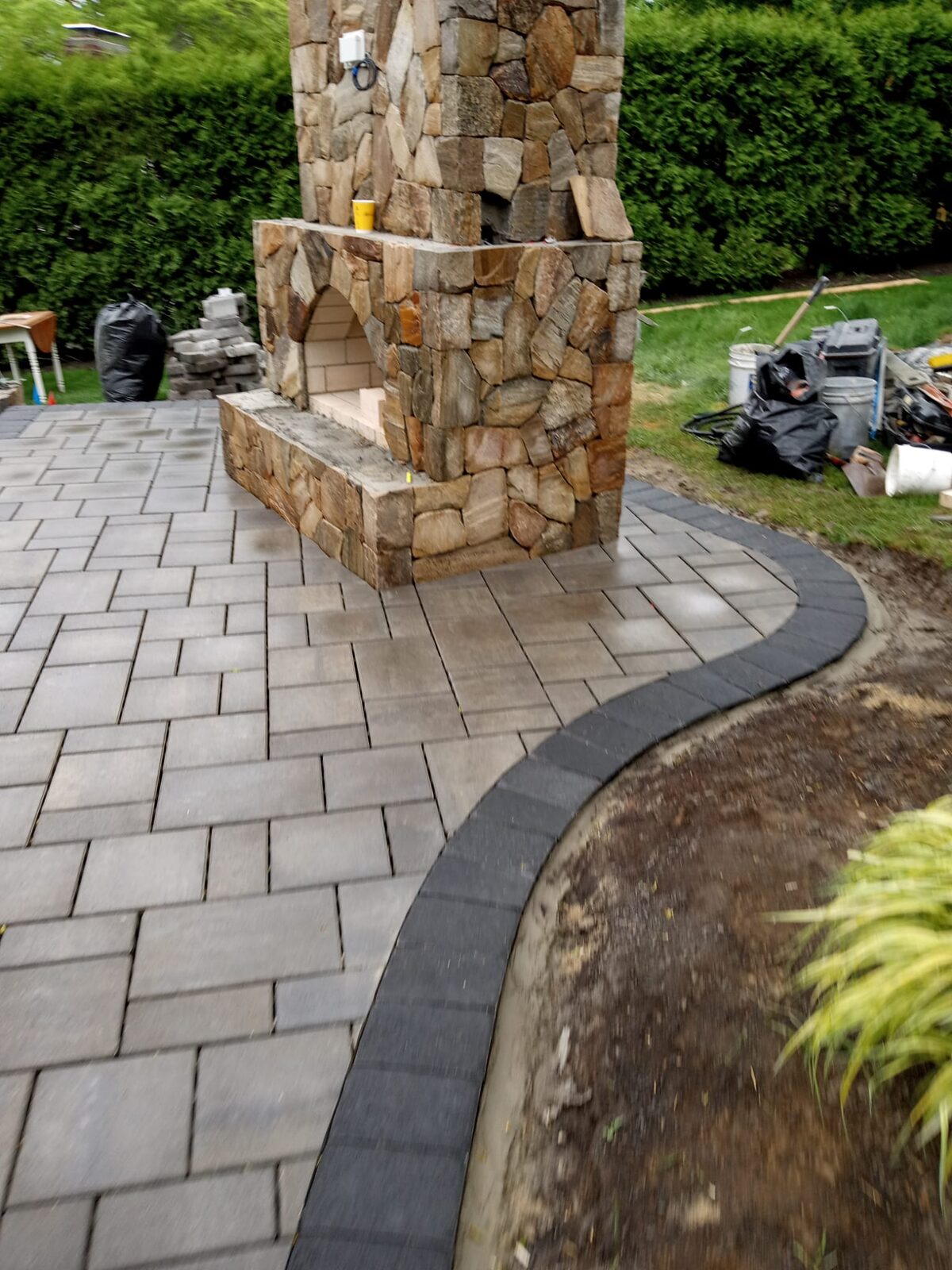 Paver patio with stone fireplace and pizza oven built by Concrete Solutions in Eastern MA