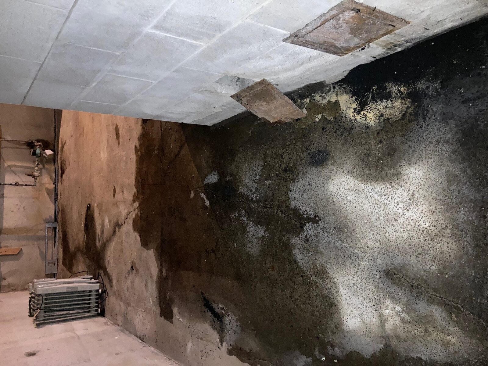 Wet basement before interior waterproofing by Concrete Solutions in Eastern Massachusetts